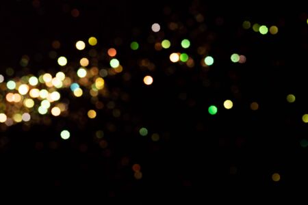 Gold glitter bokeh lights on black background, unfocused. Holiday time. overlay layerの写真素材