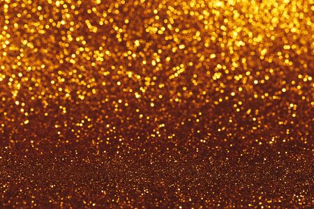 Christmas abstract texture, golden sparkles bokeh shining background.の写真素材