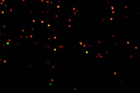 Red glitter bokeh lights on black background, unfocused. Holiday time. overlay layerの写真素材