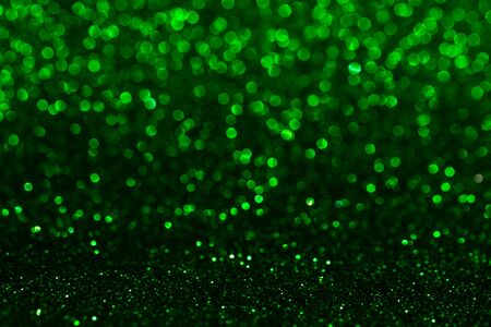 Christmas abstract texture, green sparkles bokeh shining background.の写真素材