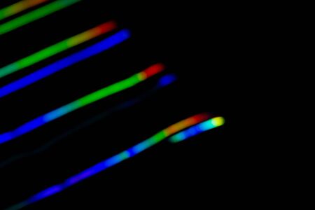 Holographic background with different colors. Holographic lines on black background. Neon line....