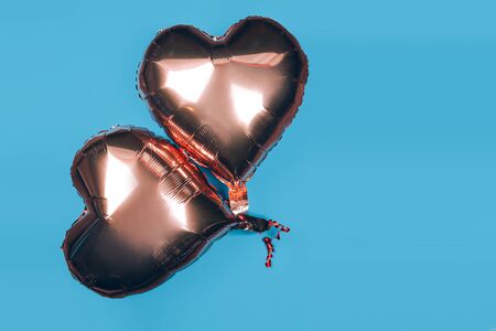 Two baloons heart shape on blue backgroundの写真素材