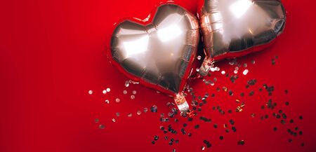 Two baloons heart shape on red backgroundの写真素材
