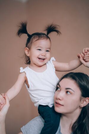 happy mother playing with her baby girlの写真素材