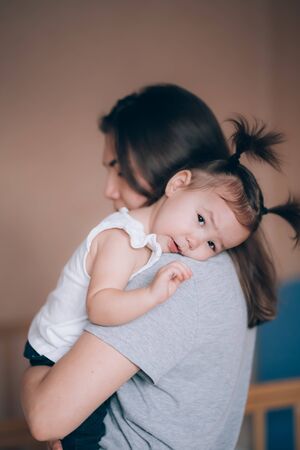 Young mother holding her little child girl.の写真素材