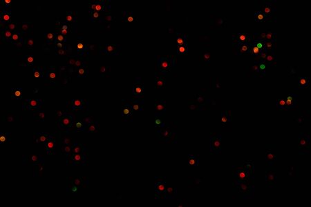 Red glitter bokeh lights on black background, unfocused. Holiday time. overlay layerの写真素材