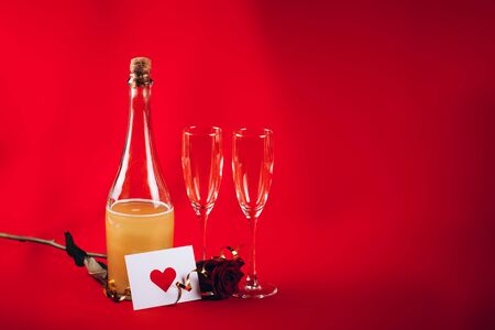 Valentines day background with champagne glasses and red roseの写真素材