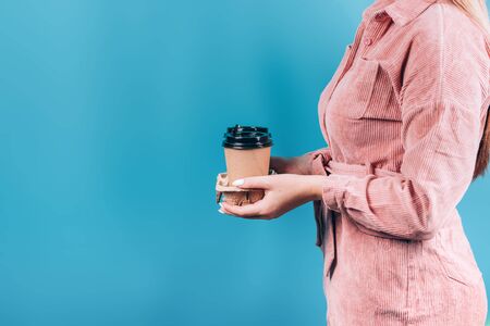 Female hand holding a Coffee paper cupの写真素材