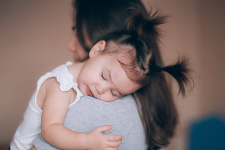 Young mother holding her little child girl.の写真素材