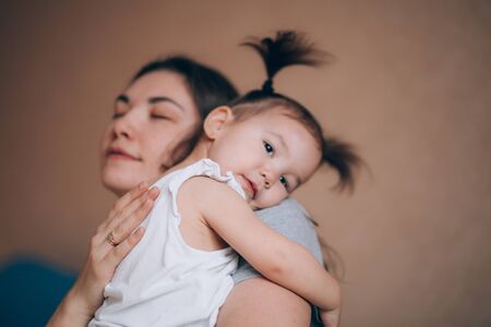 Young mother holding her little child girl.の写真素材