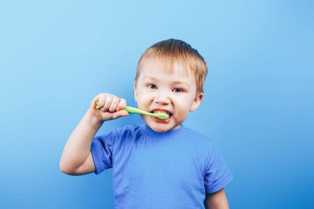 smile boy cleans a teeth with toothbrushの写真素材