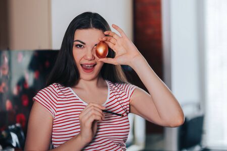 easter, holidays, woman coloring easter eggs with brush