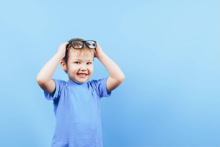 Angry small boy looking at camera in glasses
