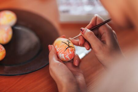 Woman paint eggs for Easter.