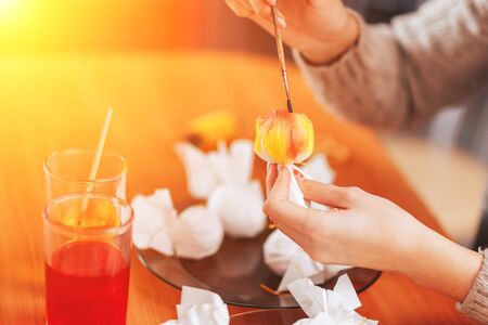 Woman paint eggs in napkins.の写真素材