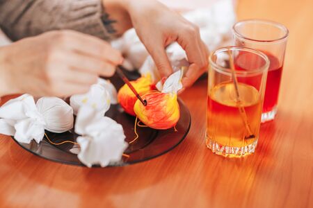 Preparing to Easter, Woman paint and color eggs with the help of napkins.の写真素材
