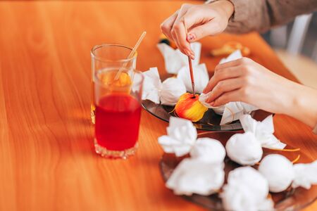 Preparing to Easter, Woman paint and color eggs with the help of napkins.の写真素材