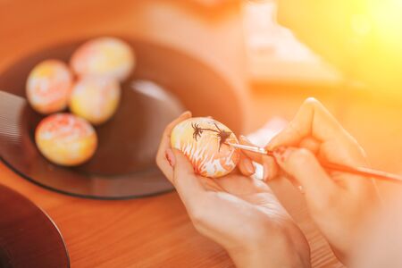 Woman paint eggs for Easter.