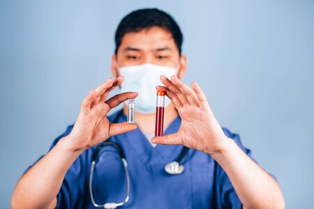 Doctor holds test tubesの写真素材
