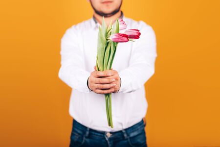 man holds tulipsの写真素材