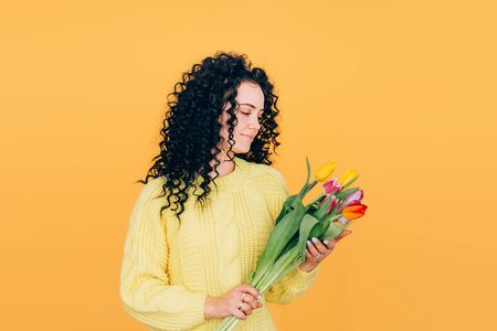 young beautiful girl holding bouquet of tulipsの写真素材