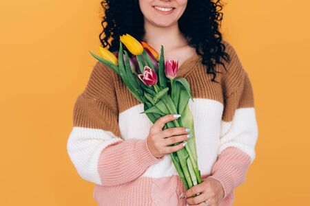 young beautiful girl holding bouquet of tulipsの写真素材