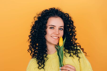 young beautiful girl holding bouquet of tulipsの写真素材