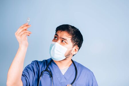 the doctor holds a test tube with medicineの写真素材