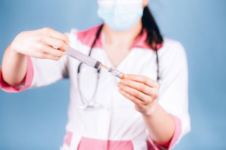 young girl doctor with a syringe in handの写真素材