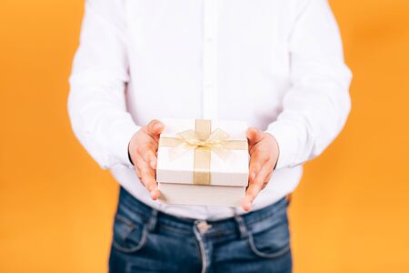 man holds a gift in his handsの写真素材