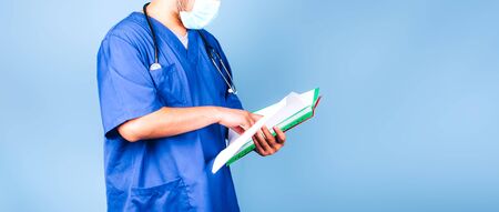 Young doctor with a red folderの写真素材
