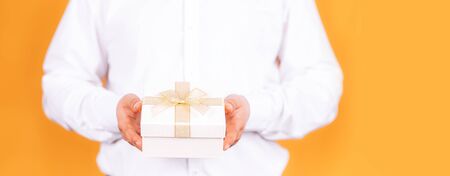 man holds a gift in his handsの写真素材