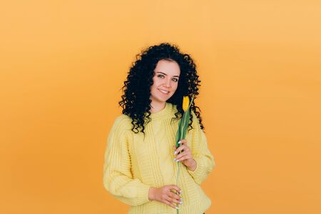 young beautiful girl holding bouquet of tulipsの写真素材