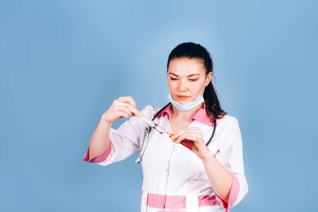 young girl doctor with a syringe in handの写真素材
