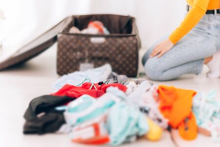 girl arranges clothes in the suitcase
