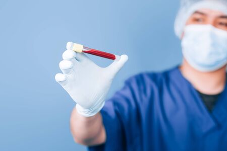 doctor holding a test tube with bloodの写真素材