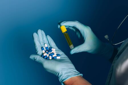 Doctor holding pills and test tubeの写真素材