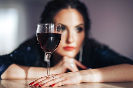 beautiful luxury woman with glass red wineの写真素材