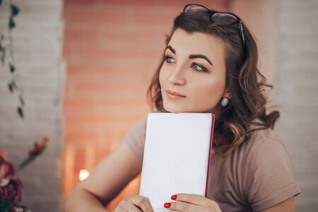 Beautiful woman reading a bookの写真素材