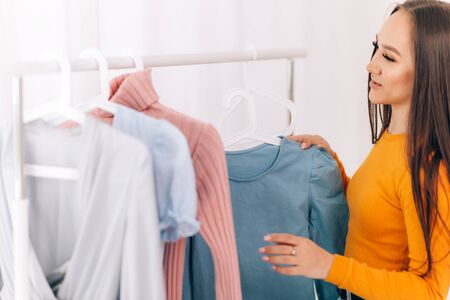 Girl chooses clothesの写真素材