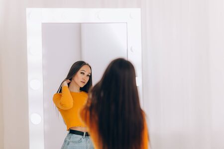 girl standing in front of mirrorの写真素材