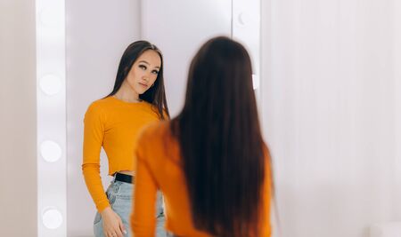 girl standing in front of mirrorの写真素材