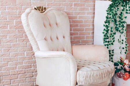 luxury interior with light coloured brick wall and leather armchair
