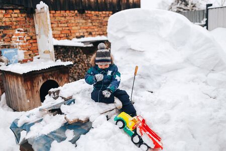 Little boy plays in the snowの写真素材