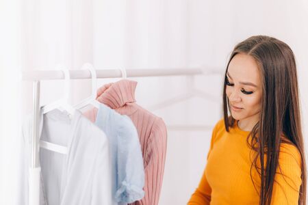 Girl chooses clothesの写真素材