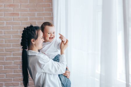 Young girl hugs little boyの写真素材