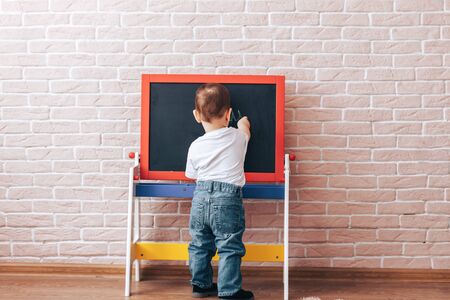 Child at the blackboardの写真素材