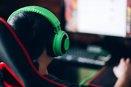computer games, playing place, young gamer plays computer games with headphones,の写真素材