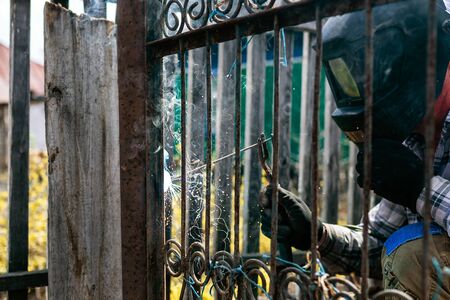 Welding metal structures at a construction site, welding a metal frame for further pouring wall cementの写真素材