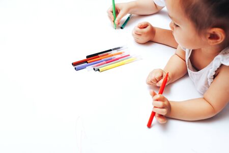 Talented children draw with colored felt-tip pens on white paper, lessons, tasks with children of the different ages.の写真素材